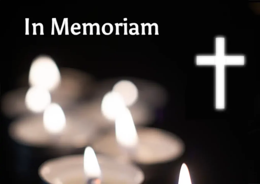 In Memoriam with tealight candles and white cross on a black background
